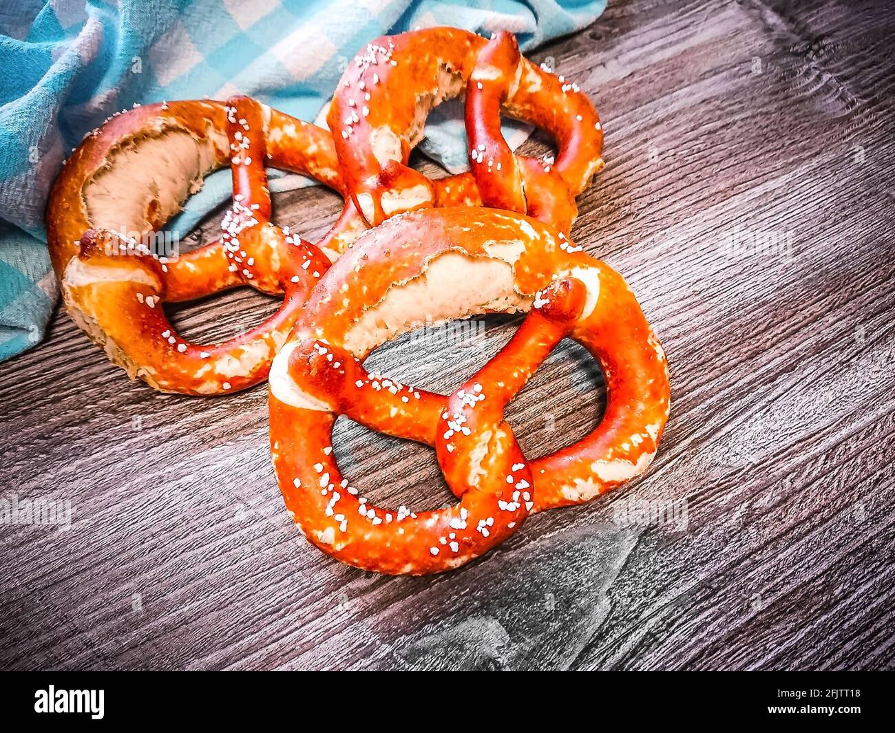 Three delicious bavarian pretzels at table, top view Stock Photo