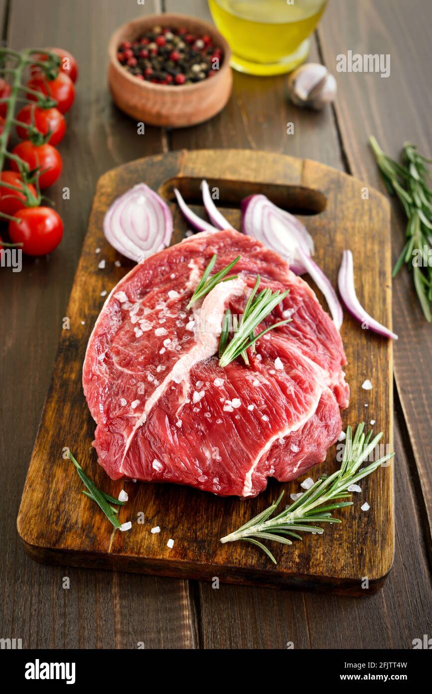 Raw beef steak on cutting board, close up view Stock Photo
