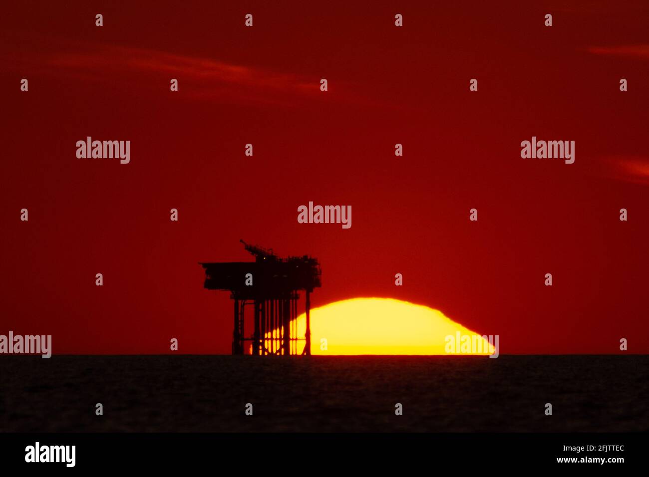 Sunset over the Lennox oil platform or rig in the Irish sea a few miles ...