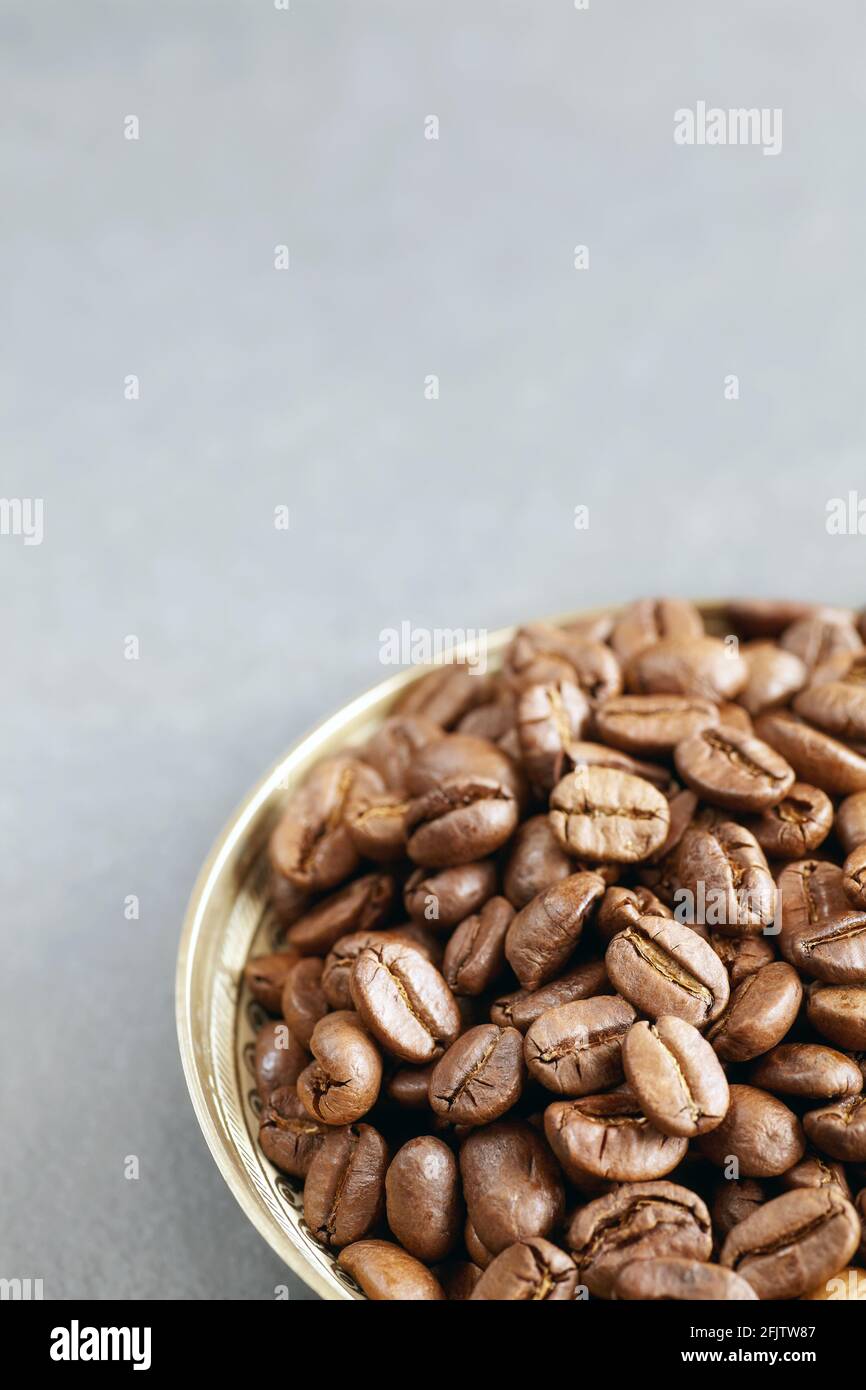 Roasted coffee beans in a bowl, selective focus, space for text. Stock Photo
