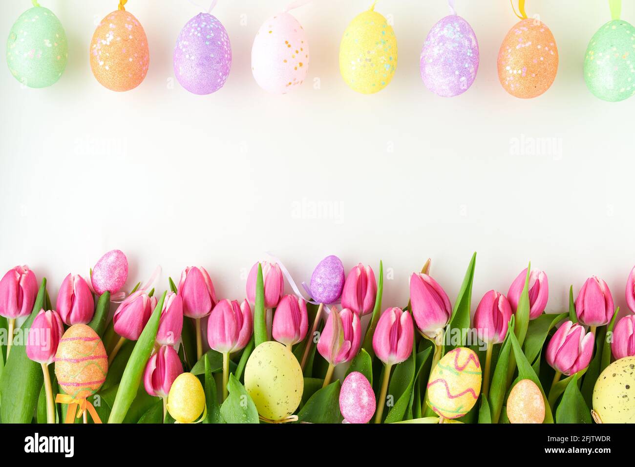 spring flat lay with tulips and easter eggs isolated on white ...