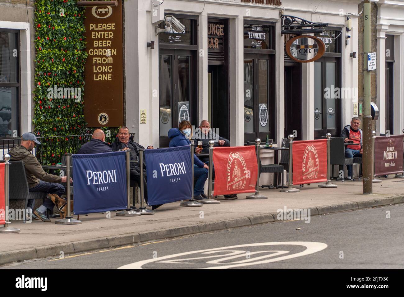 Broughty Ferry, Tayside, Dundee, Scotland, 26th of Apr 2021: Punters enjoying a drink, at their local (The Fort) in Broughty Ferry, after the scottish government relaxed lockdown restrictions in Scotland, which allows pubs throughout the country to reopen until 10pm, as long as they have an outside beer garden. Hospitality has been closed during this second lockdown in scotland. Credit: Barry Nixon Stable Air Media/Alamy Live News Stock Photo