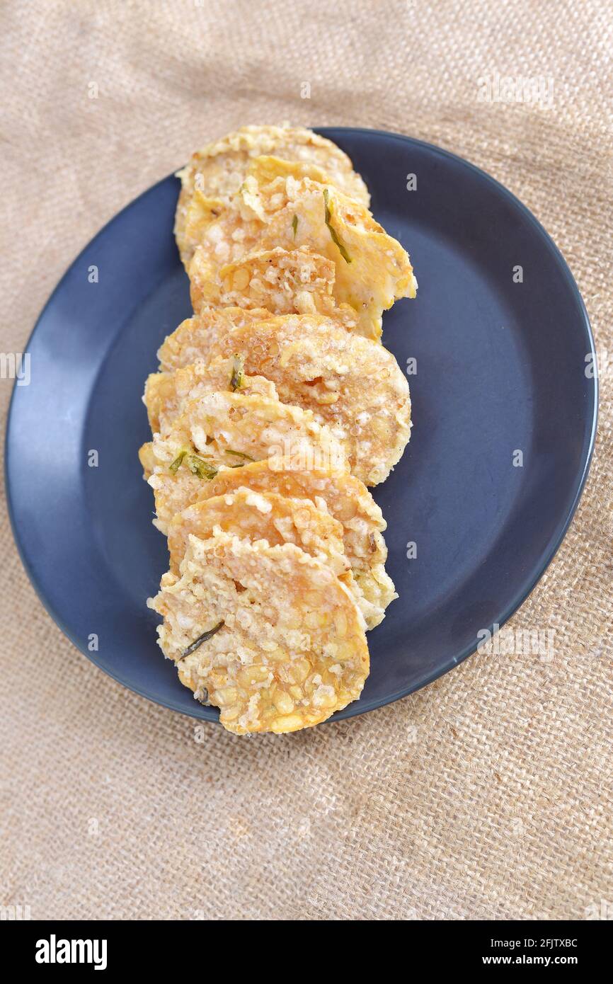 Keripik tempe , tempeh crackers in a plate. Indonesian traditional snack. brown texture
