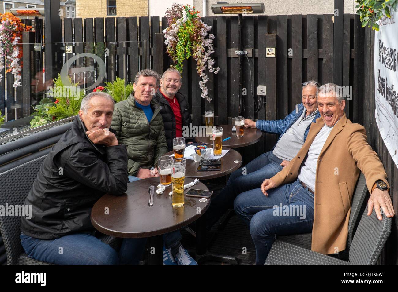 Broughty Ferry, Tayside, Dundee, Scotland, 26th of Apr 2021: Punters enjoying a drink, at their local (The Fort) in Broughty Ferry, after the scottish government relaxed lockdown restrictions in Scotland, which allows pubs throughout the country to reopen until 10pm, as long as they have an outside beer garden. Hospitality has been closed during this second lockdown in scotland. Credit: Barry Nixon Stable Air Media/Alamy Live News Stock Photo