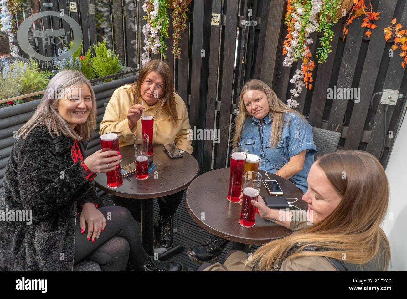 Broughty Ferry, Tayside, Dundee, Scotland, 26th of Apr 2021: Punters enjoying a drink, at their local (The Fort) in Broughty Ferry, after the scottish government relaxed lockdown restrictions in Scotland, which allows pubs throughout the country to reopen until 10pm, as long as they have an outside beer garden. Hospitality has been closed during this second lockdown in scotland. Credit: Barry Nixon Stable Air Media/Alamy Live News Stock Photo