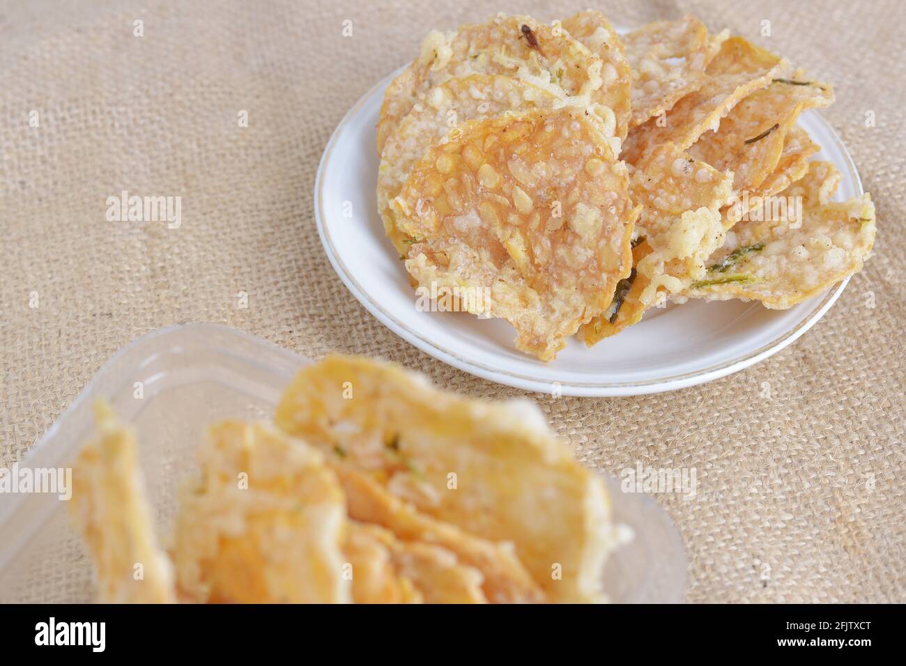 Keripik tempe , tempeh crackers in a plate. Indonesian traditional snack. brown texture