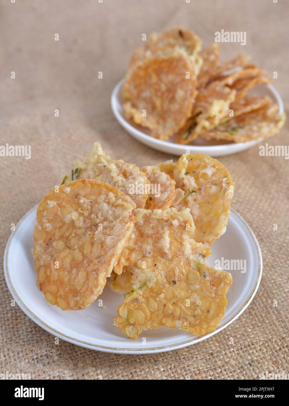 Keripik tempe , tempeh crackers in a plate. Indonesian traditional snack. brown texture