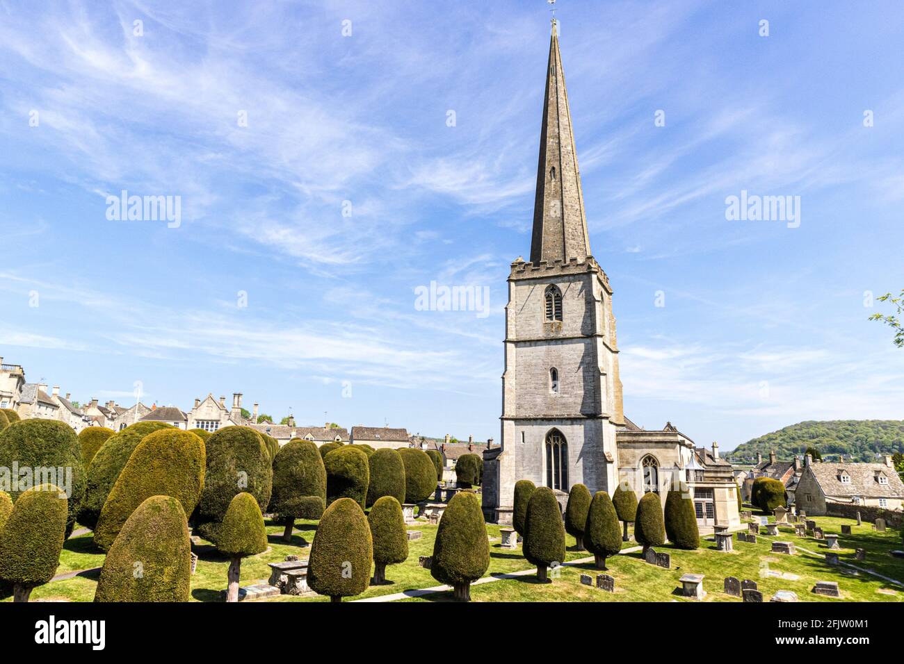 St Marys church with some of its 99 yew trees in the Cotswold village of Painswick, Gloucestershire UK Stock Photo