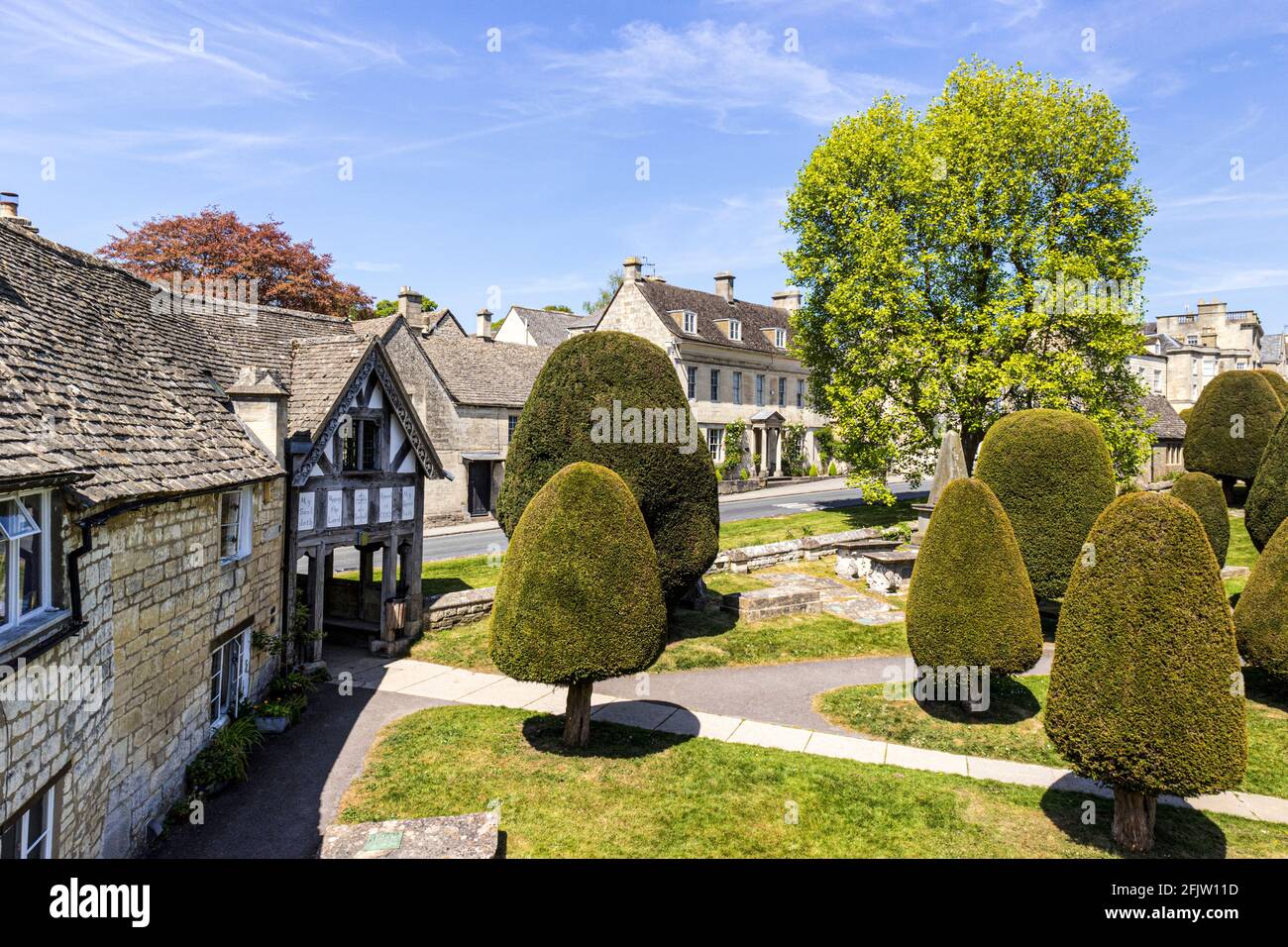 St Marys church lych gate with some of its 99 yew trees in the Cotswold village of Painswick, Gloucestershire UK Stock Photo