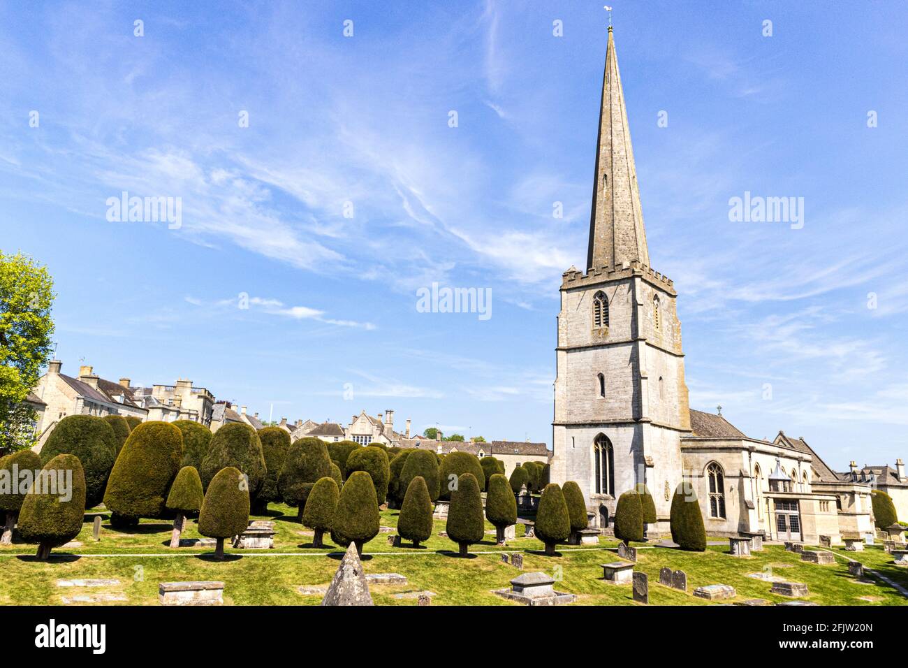 St Marys church with some of its 99 yew trees in the Cotswold village of Painswick, Gloucestershire UK Stock Photo