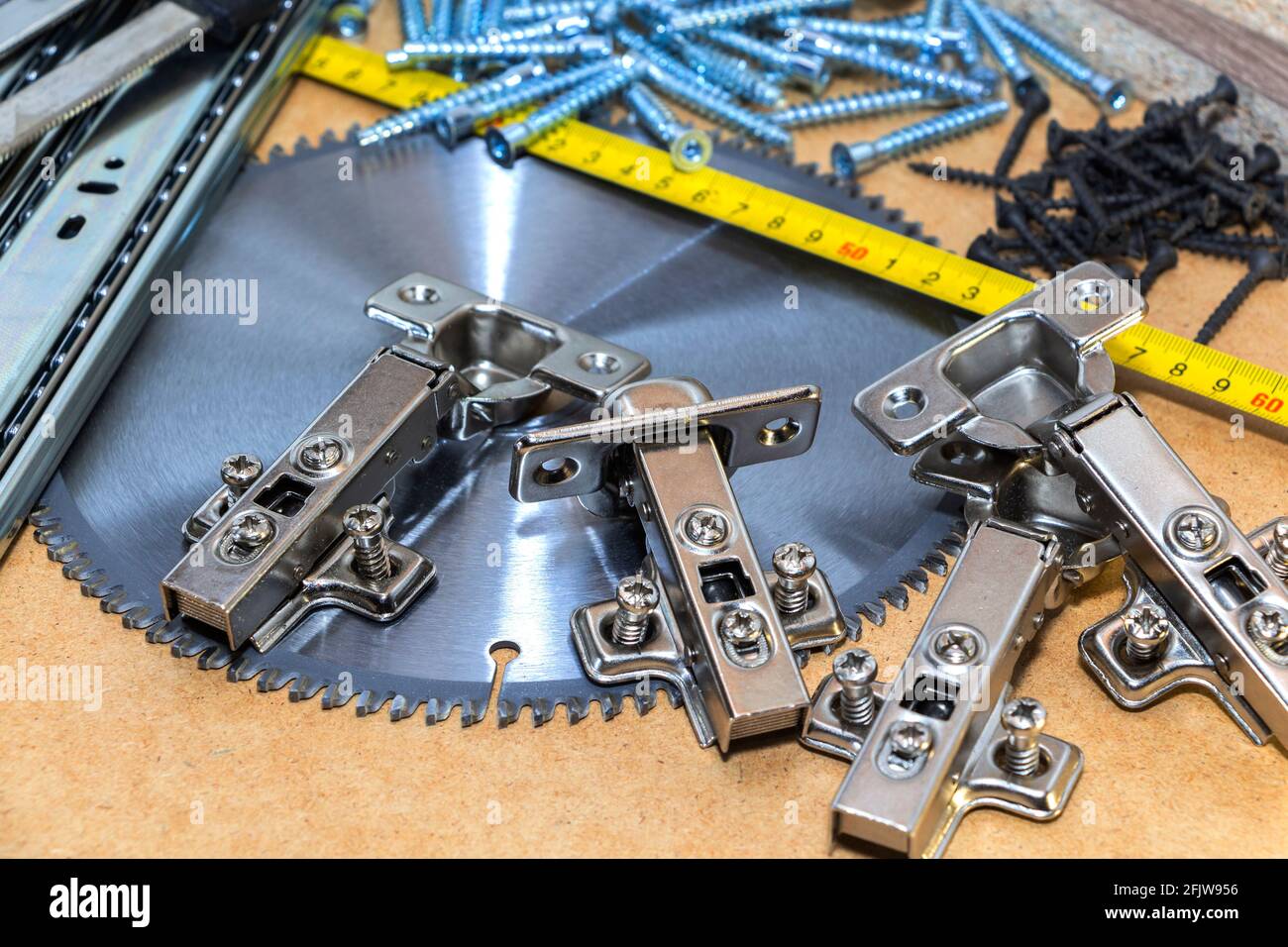 Carpenter tools on wooden table with sawdust. Circular Saw. Stock Photo