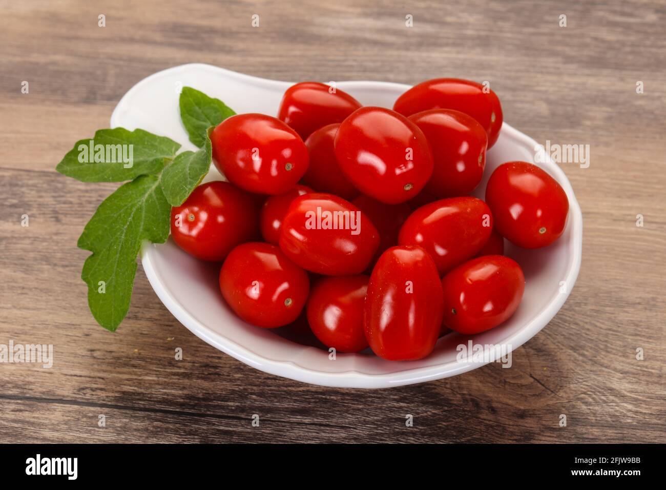 Sweet Red cherry tomatoes in the bowl Stock Photo - Alamy