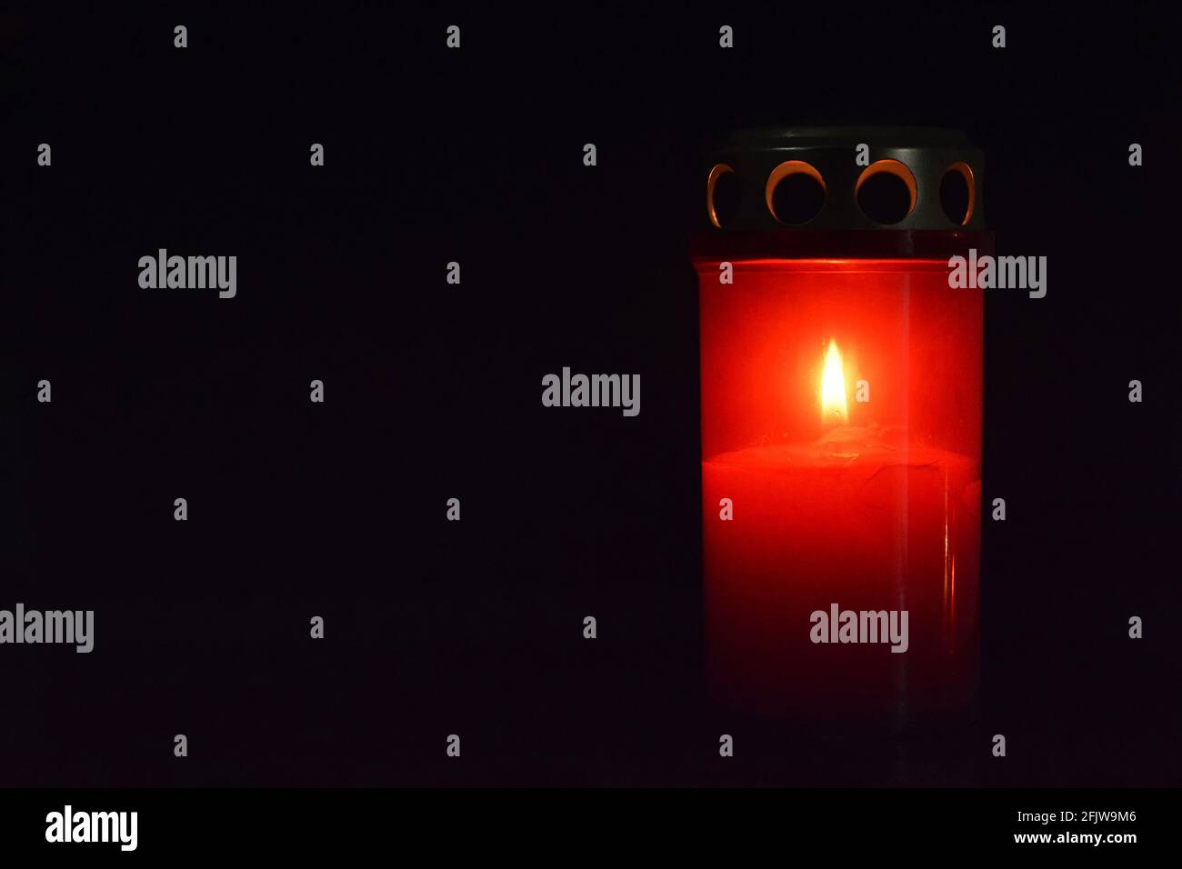 Grave candle on dark background with copy space Stock Photo