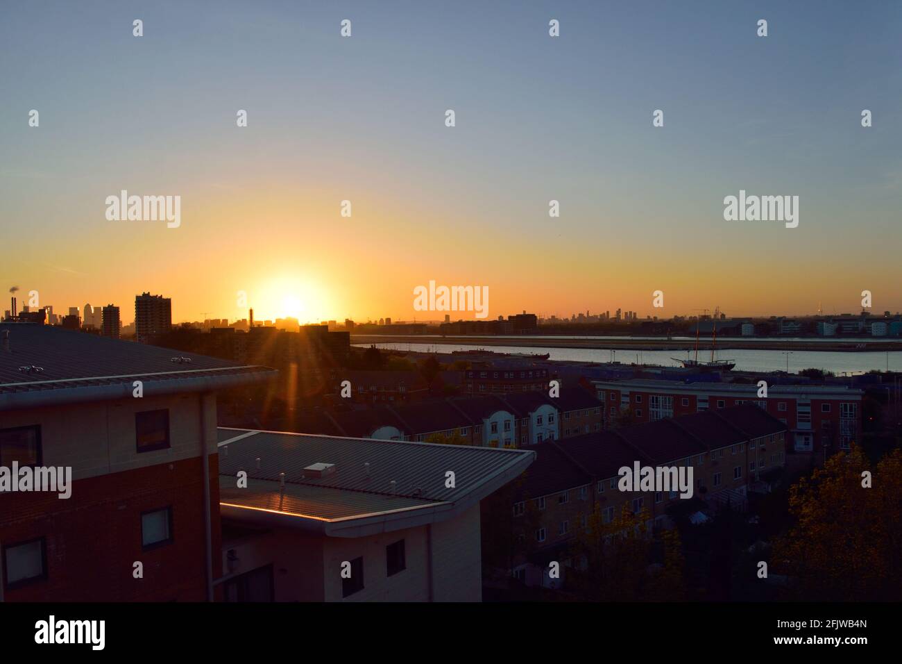 Sunset as seen looking over the Royal Docks area of Newham in East London Stock Photo