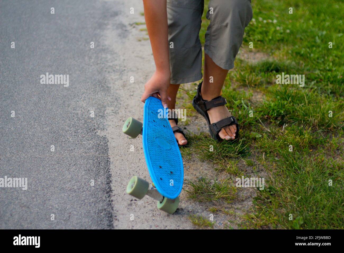 Defocus Little Boy Holding A Penny Skateboard Young Kid Riding In The Park On A Skateboard Child Learns To Ride A Blue Penny Board And Doing Tricks Stock Photo Alamy