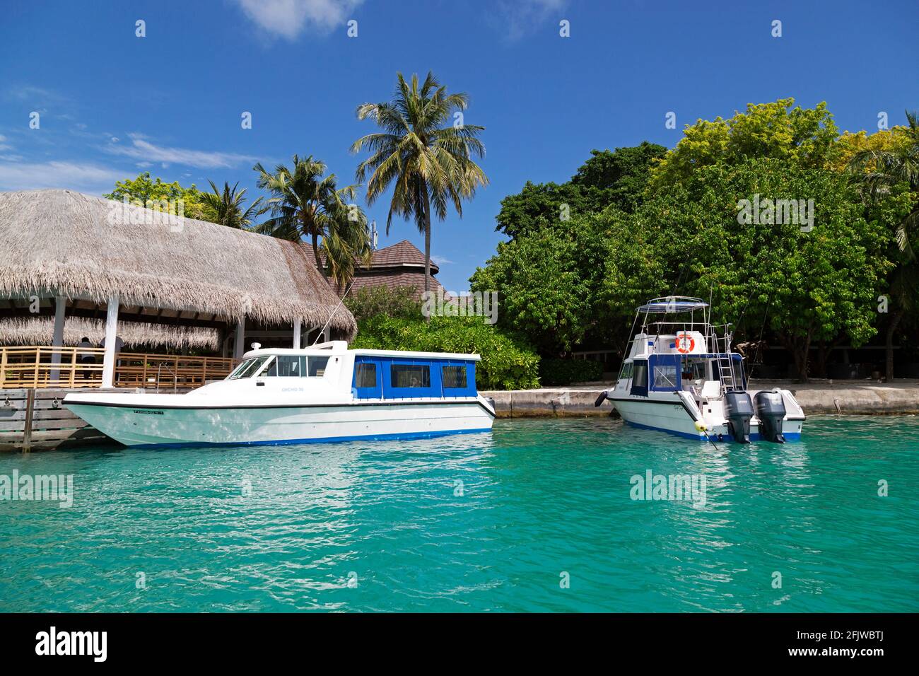 Motor boats at the jetty at Bandos Island in the Maldives. The Maldives is a popular holiday tropical destination in the Indian Ocean and speed boats Stock Photo