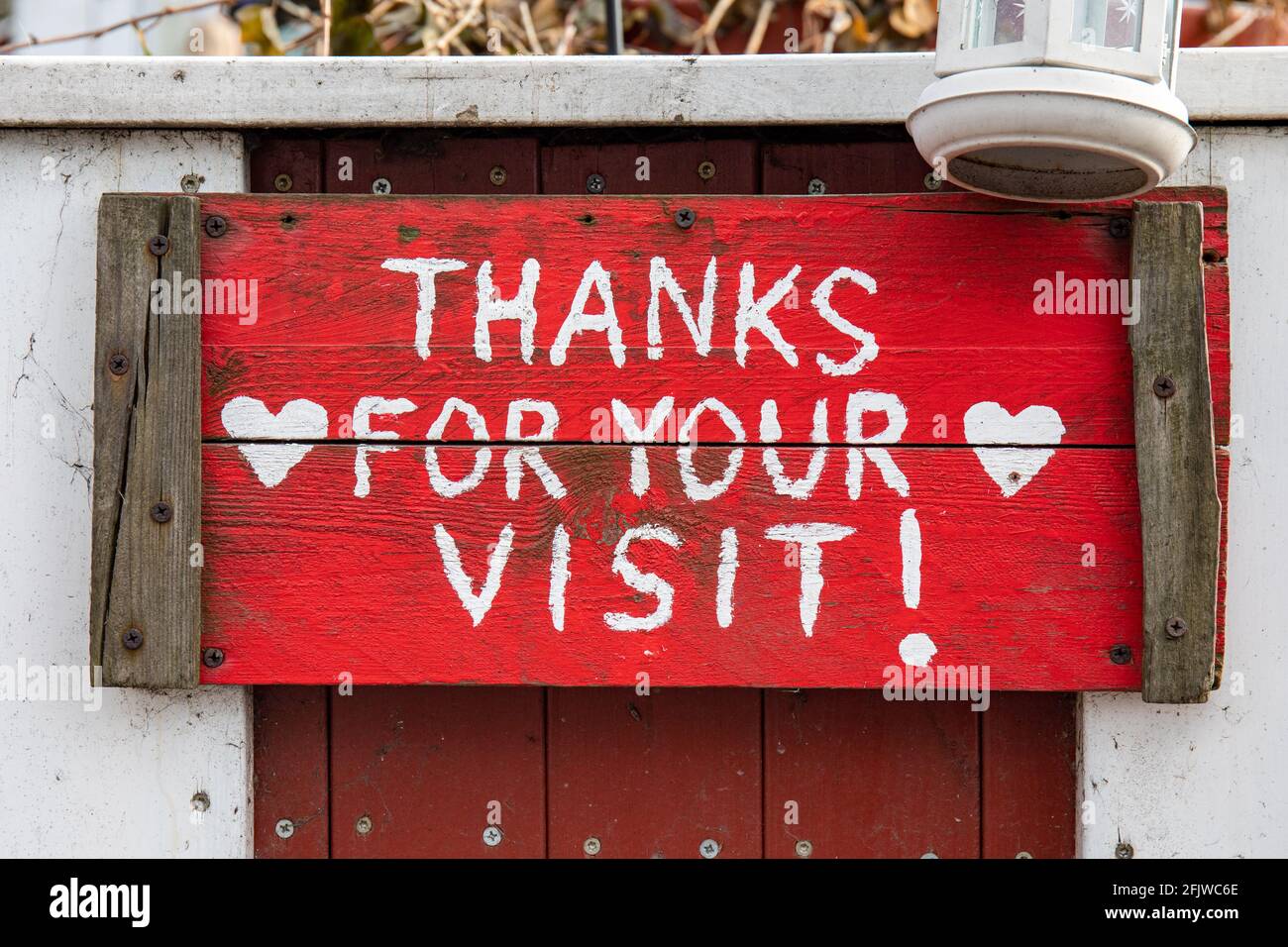 Thanks for your visit! Red wooden sign at Café Regatta in Taka-Töölö district of Helsinki, Finland. Stock Photo