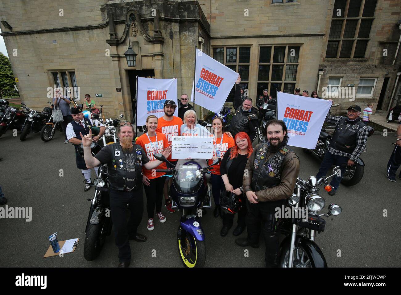 HollyBush, Ayrshire , Scotland, UK. 02 Jun 2018. Hollybush house is the location for the military support service Combat Stress. Every July a Gala day is held to raise funds and awareness. Local motorcycle group "The Hillbillies " present a cheque for £1900 to Kath Provan the fund raising manager Stock Photo