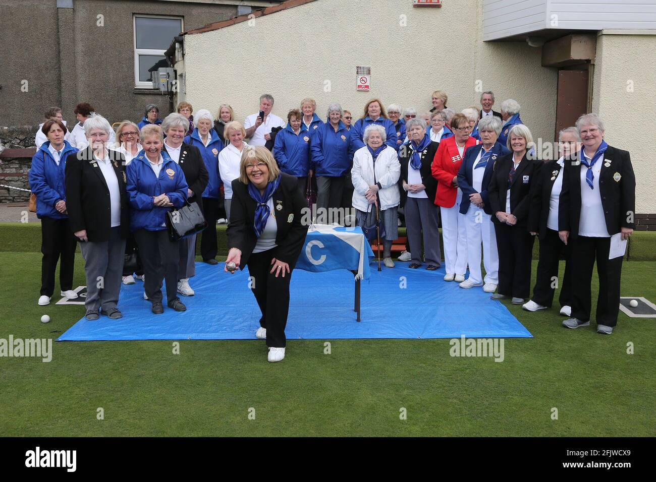 Troon Porland Ladies Bowling Club, Ayrshire, Scotland, UK Lady President Morag Boyle throws the silver jack at the start of the bowling season. 15 Apr 2018 Stock Photo