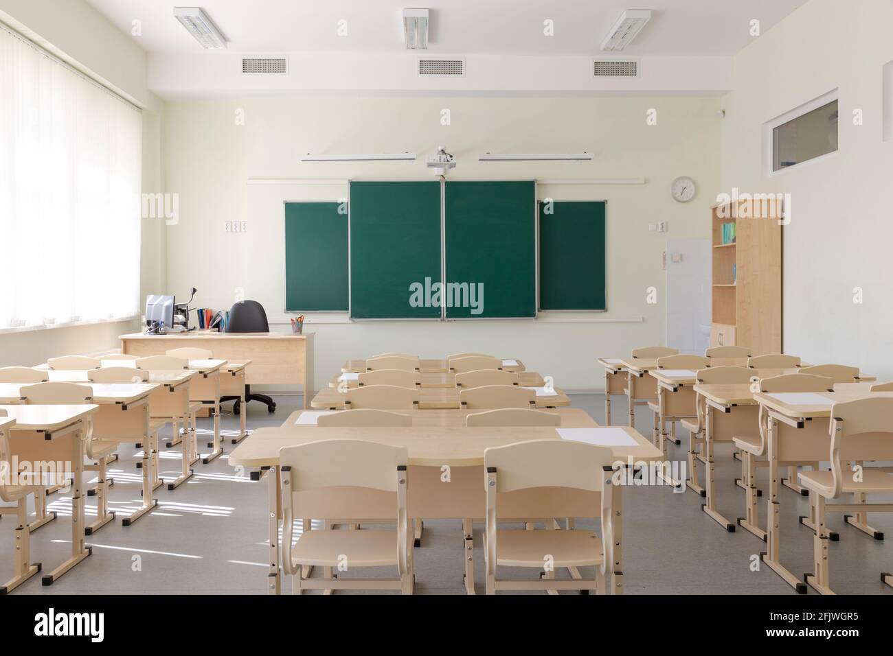 empty school class before final exams. Sheets for tests are laid out on ...
