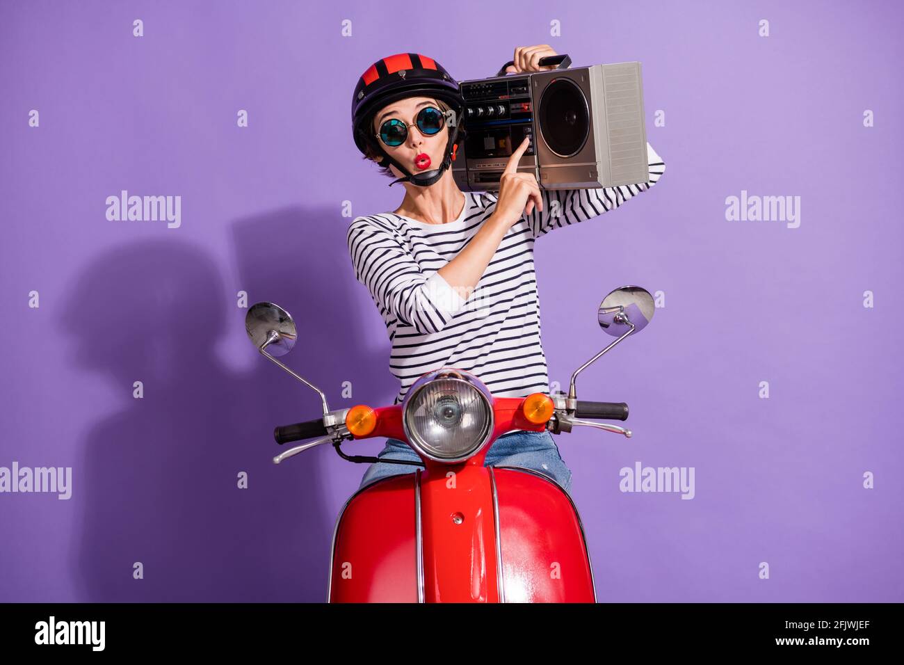 Portrait photo of girl in helmet motorbike pressing on button listening