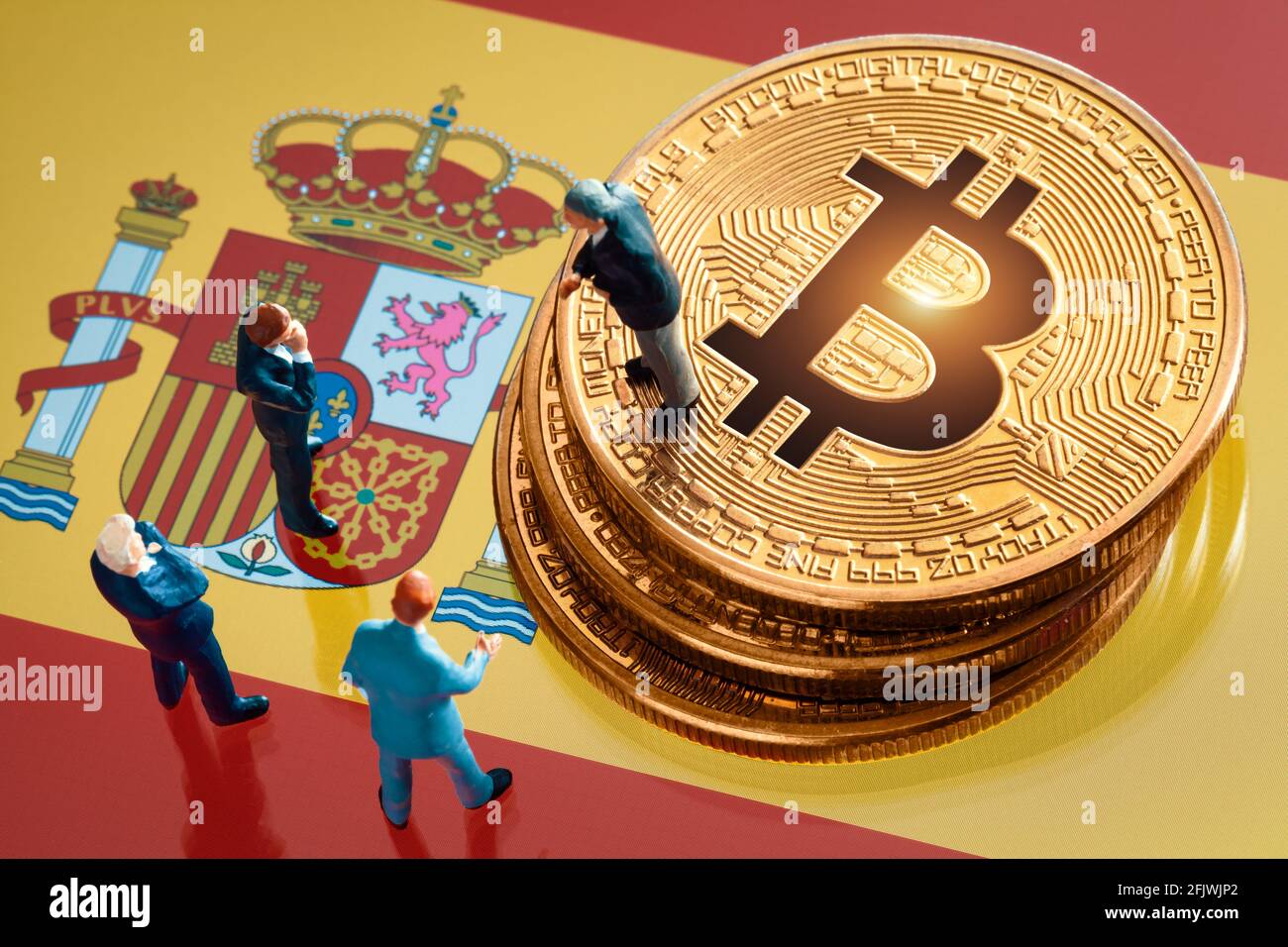 Business meeting about the investment decision for bitcoin concept: Miniature businessman figurines standing near the pile of shiny golden bitcoin on Stock Photo
