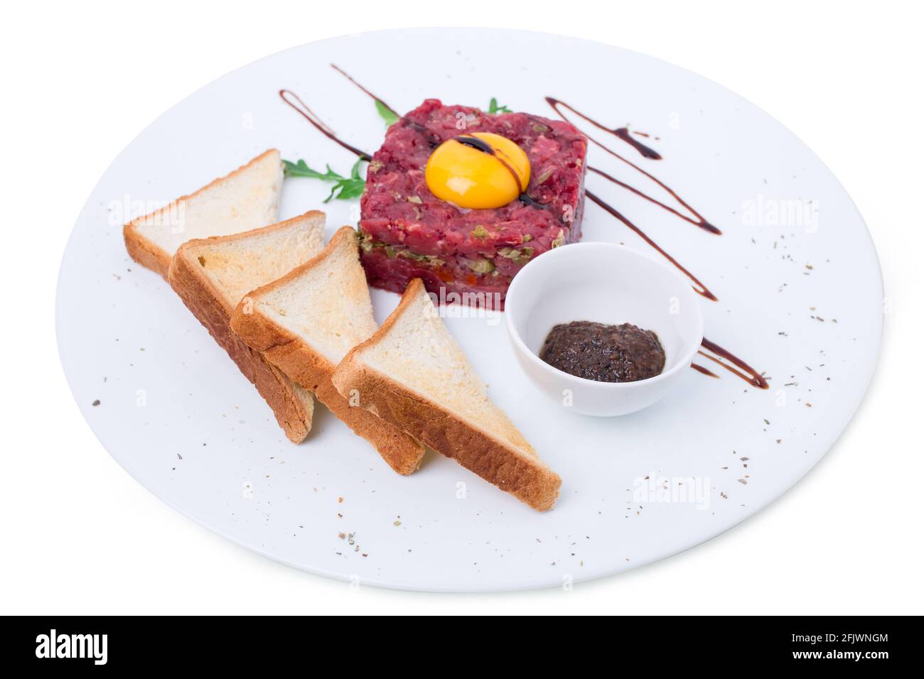 Delicious steak tartare covered with soya sauce with egg yolk and sauce