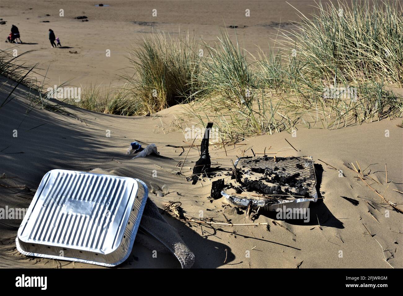 Disposable barbecue left on a beach unattended. Local councils and fire brigades across the country are asking them not to be used in this heatwave Stock Photo