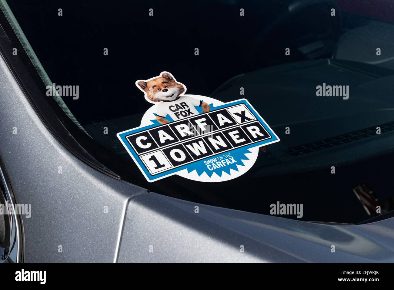 Plainfield - Circa April 2021: Carfax sticker on a used pre-owned vehicle. Carfax provide vehicle reports for prospective buyers that may reveal probl Stock Photo
