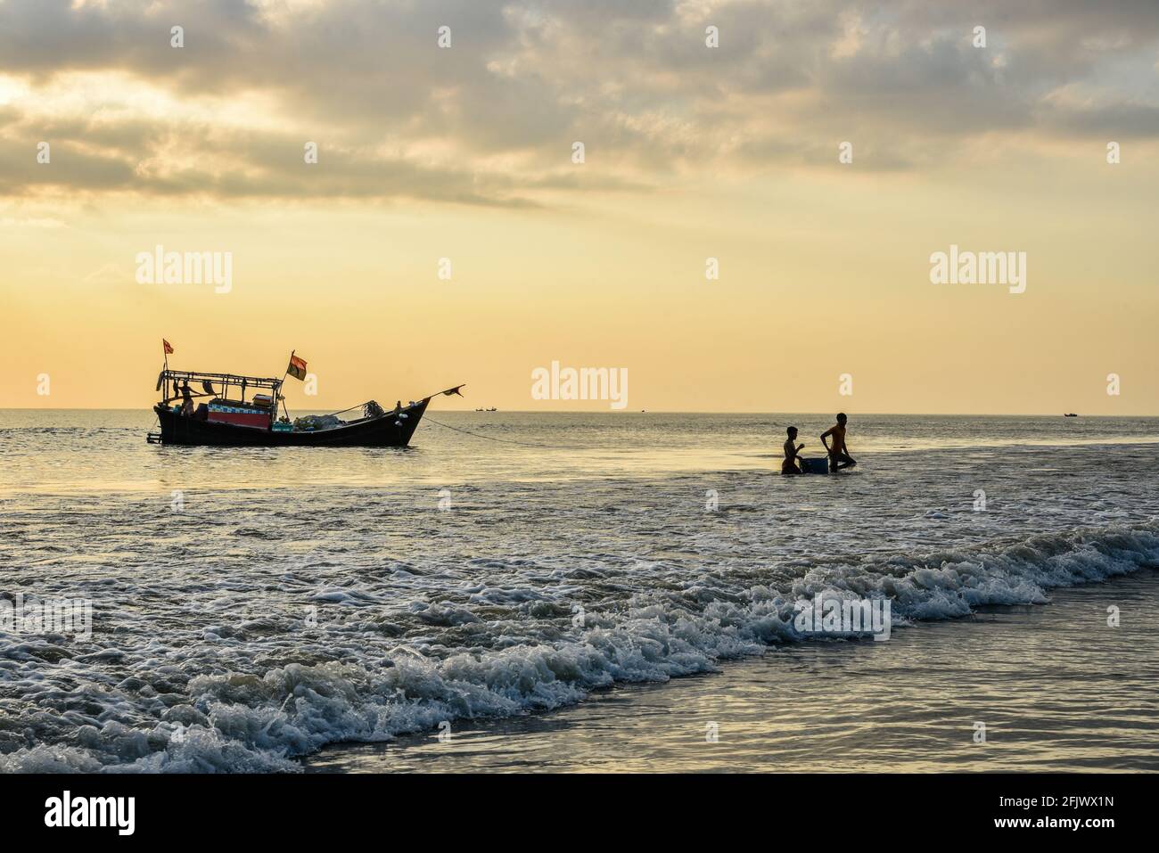 The local fish sellers capturing the fishes and bringing them in the local sea fish market. Stock Photo