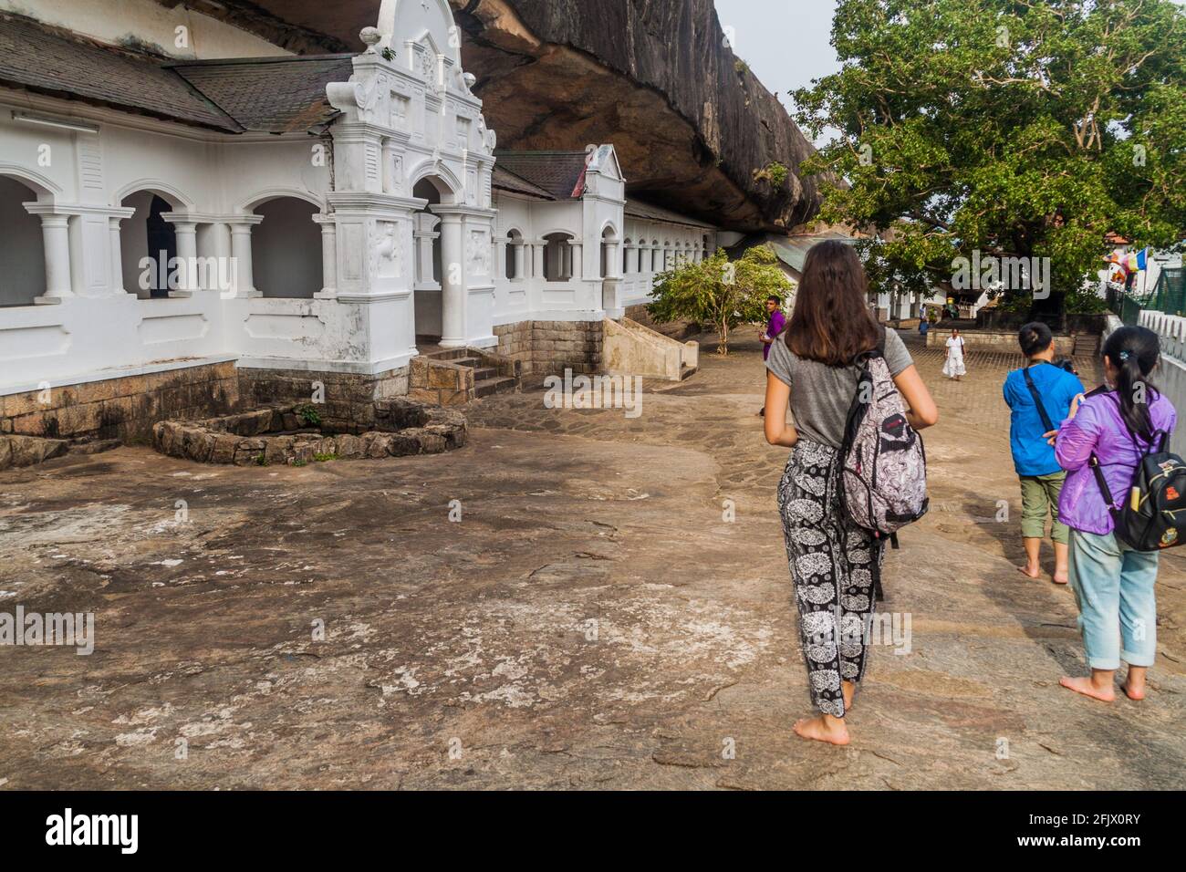 DAMBULLA, SRI LANKA - JULY 20, 2016: Tourists and devotees visit Dambulla cave temple, Sri Lanka Stock Photo
