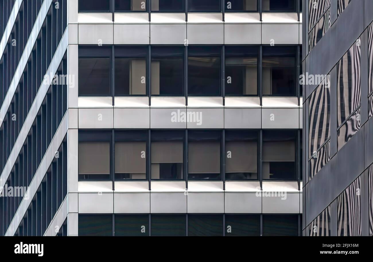 Glass and metal grid pattern of ribbon windows in Manhattan office skyscrapers,1180 and 1166 Avenue of the Americas. Stock Photo