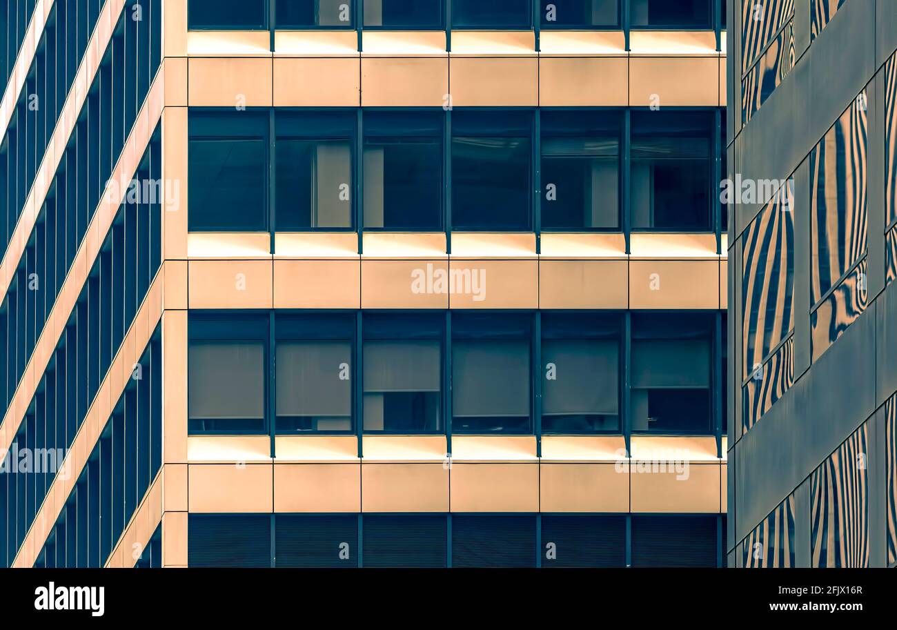 Glass and metal grid pattern of ribbon windows in Manhattan office skyscrapers, 1180 and 1166 Avenue of the Americas. (colorized) Stock Photo