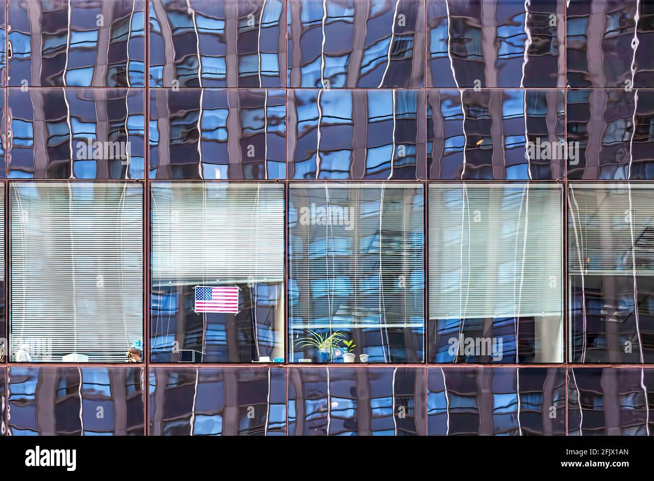 125 West 55th Street (Avenue of the Americas Plaza) reflects NY Hilton's northern tower facade - a grid within a grid. Stock Photo