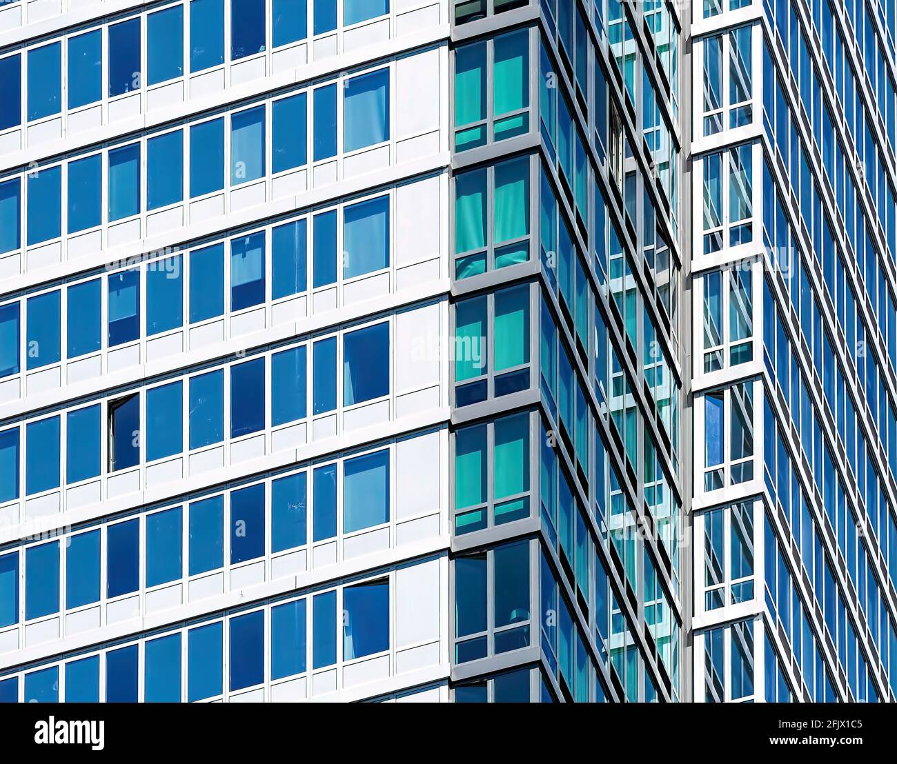 Ribbon windows of an Brooklyn apartment tower, create zig-zag pattern of blue and white. Stock Photo