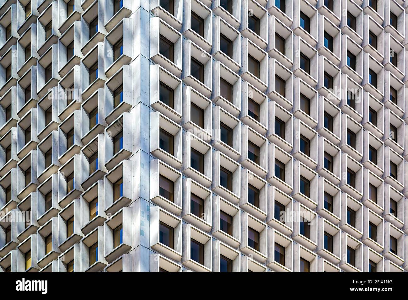 The bold pattern of deepset windows changes with the sun's position