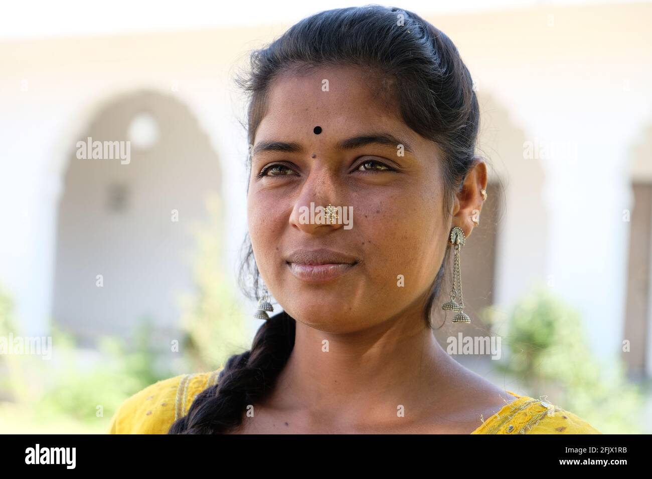 Portrait of a young Indian female with a long braid and in traditional clothes saree/sari Stock Photo
