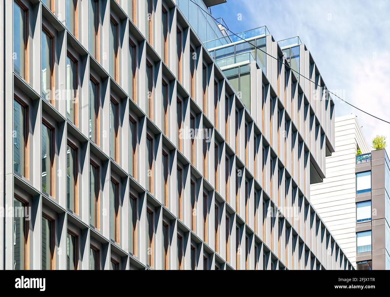 The bold pattern of deepset windows changes with the sun's position