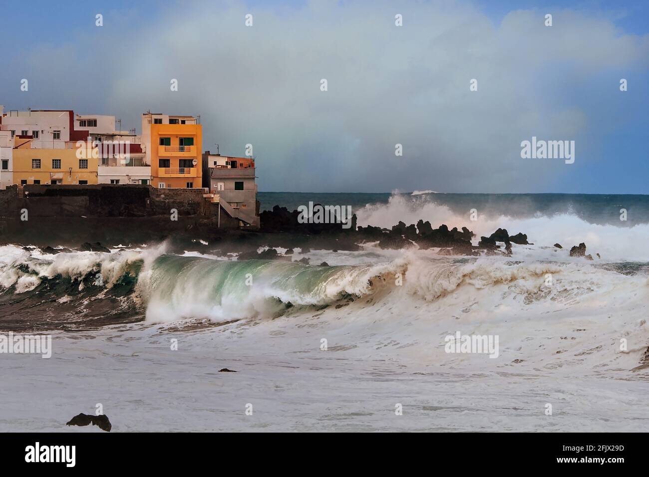 View of the tip of the old fishing village 'Punta Brava' on the north coast of the Canary Island Tenerife with high, rolling waves Stock Photo