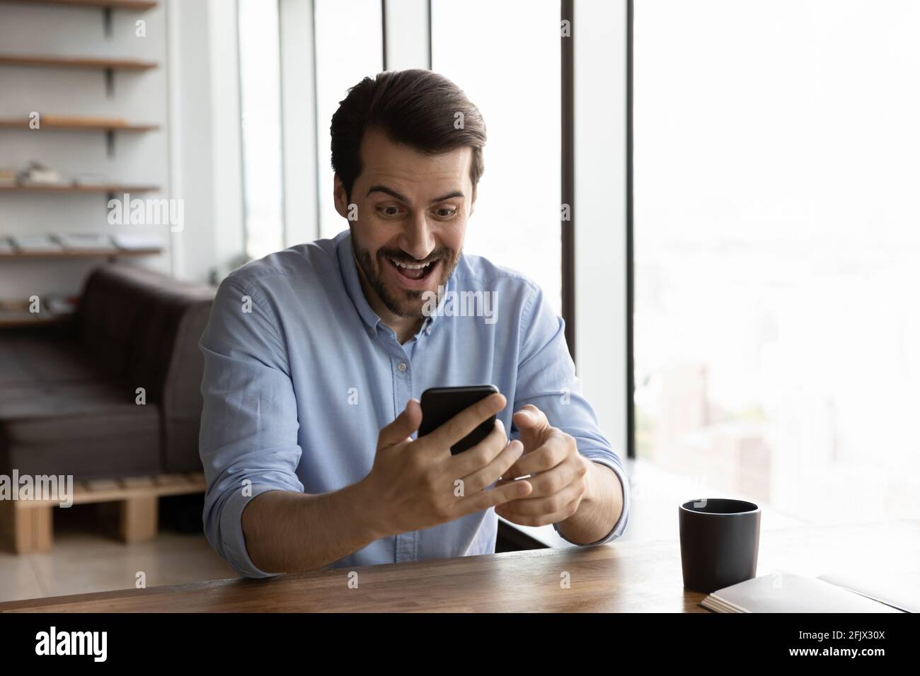 Excited young man celebrating hi-res stock photography and images - Alamy