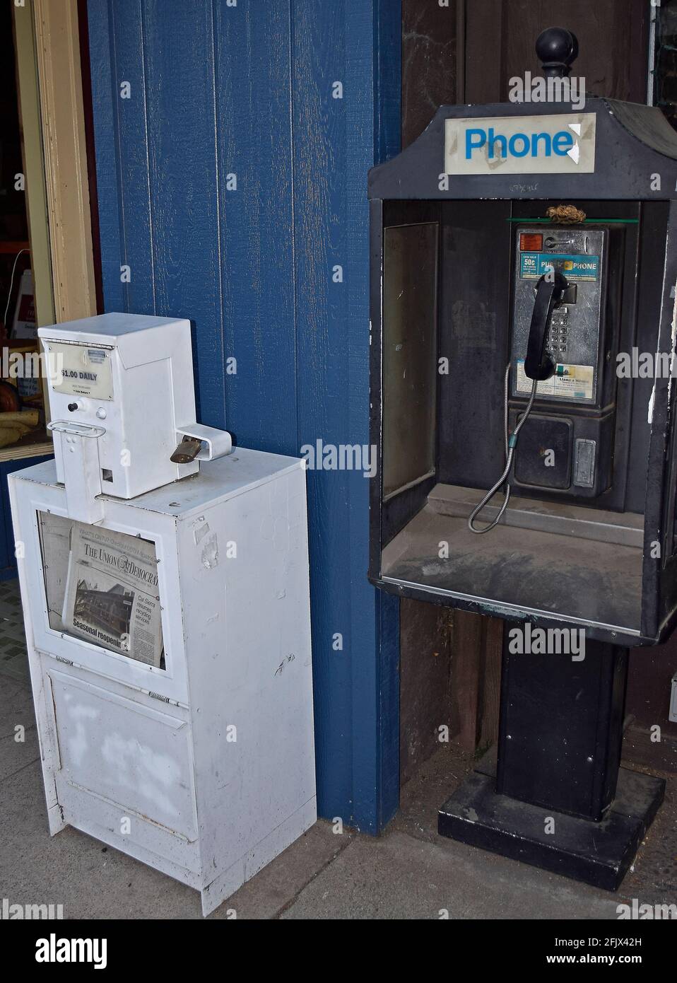 pay phone and newspaper box in Sonora, California Stock Photo