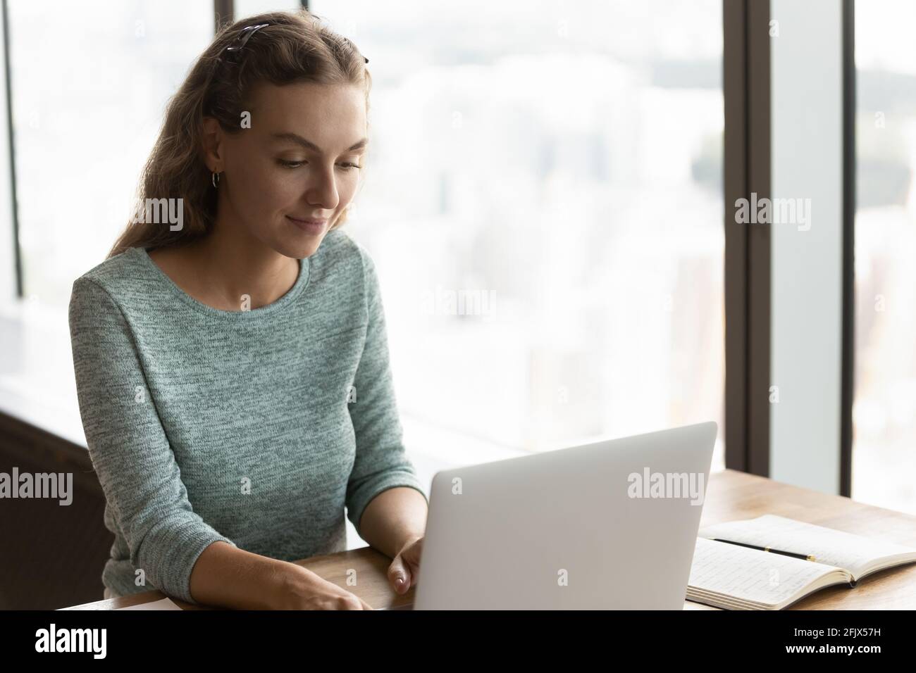 Caucasian female employee work on laptop in office Stock Photo - Alamy