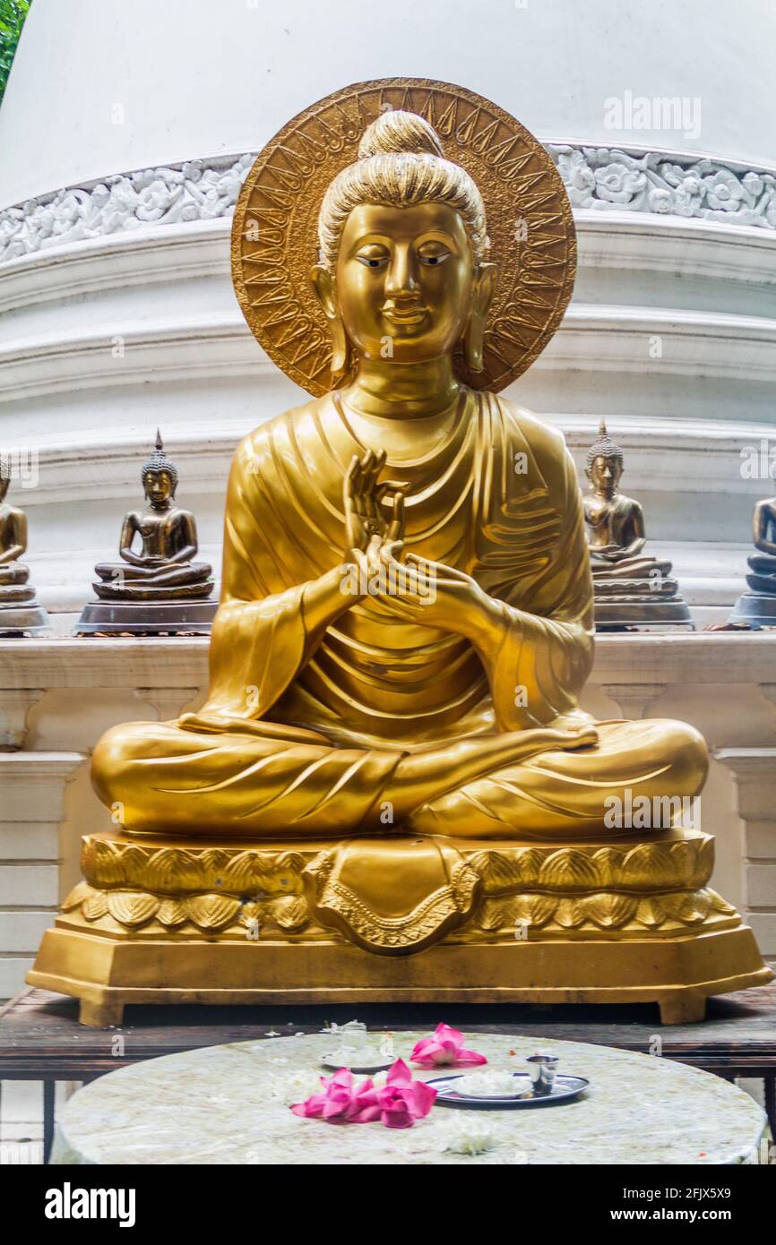 Buddha statue in Gangaramaya Buddhist Temple in Colombo, Sri Lanka Stock Photo