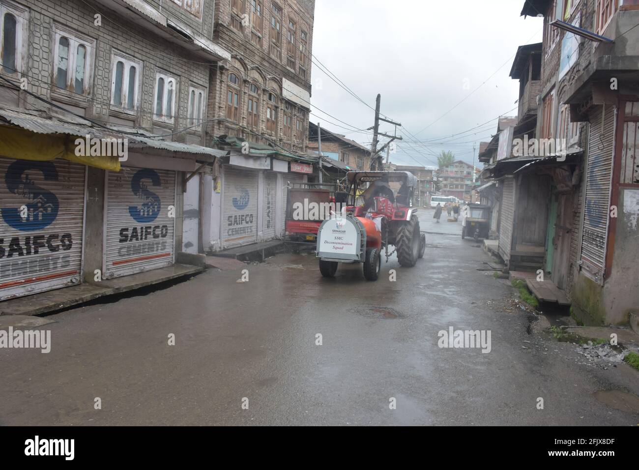 Srinagar, Jammu and kashmir India 07 August 2020. Fumigation of streets and houses by Kit wearing men warriors sanitizing and also parts of srinagar c Stock Photo