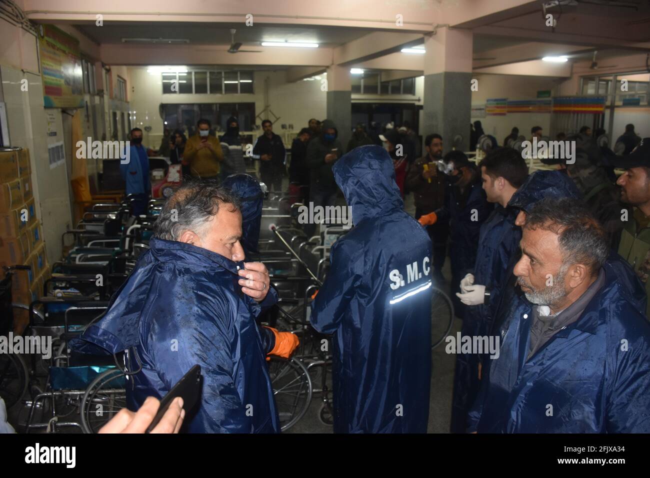 Srinagar, Jammu and kashmir India 07 August 2020. Blue kit wearing men doing fumigation indoor buildings houses complexes hospitals and schools and du Stock Photo