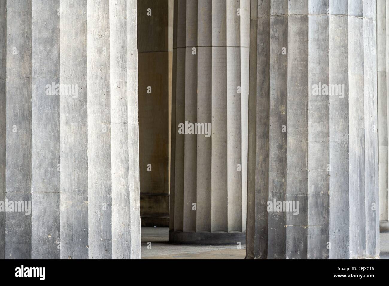 Closeup of beautiful smooth, fluted pillars leading into a temple Stock