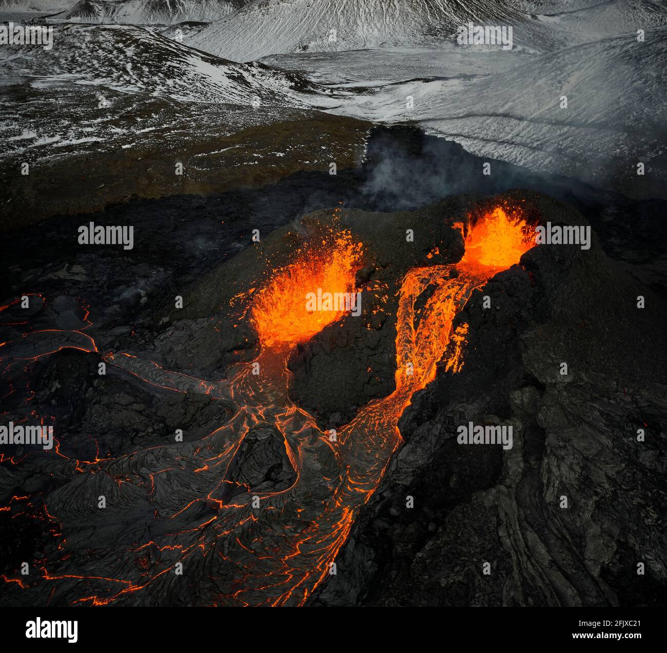 Erupting volcanic mountain with hot lava Stock Photo