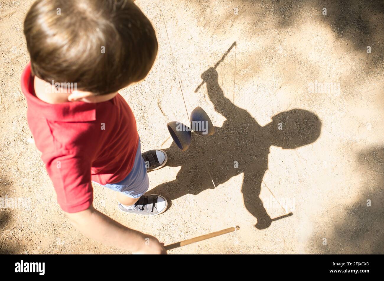 Little boy learning to use diabolo i the park Stock Photo