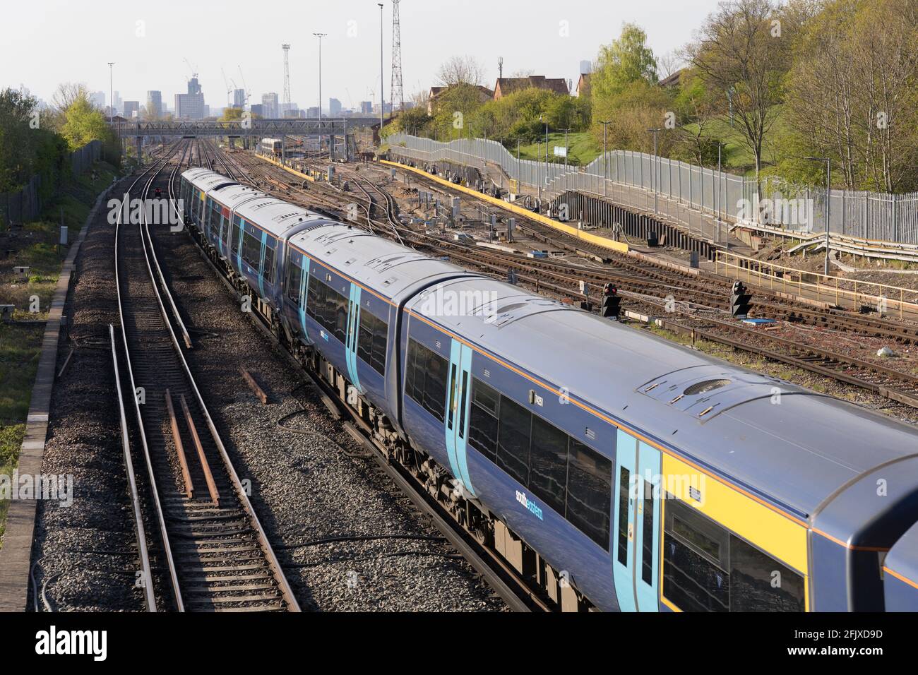 Commuter train travelling on network rail out of central London, train track, England Stock Photo