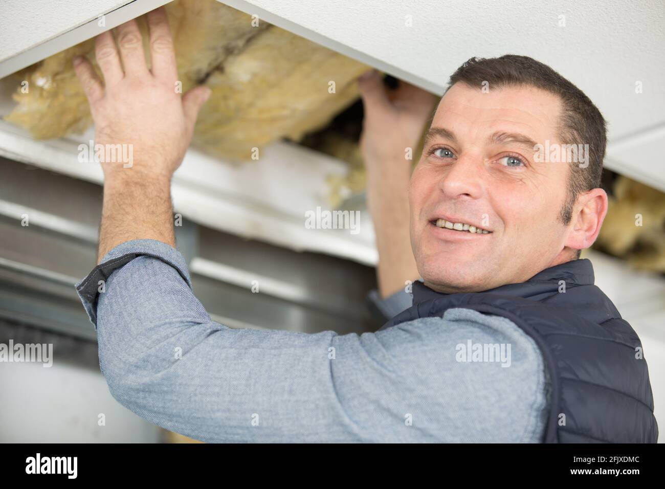 man fitting roof insulation Stock Photo Alamy